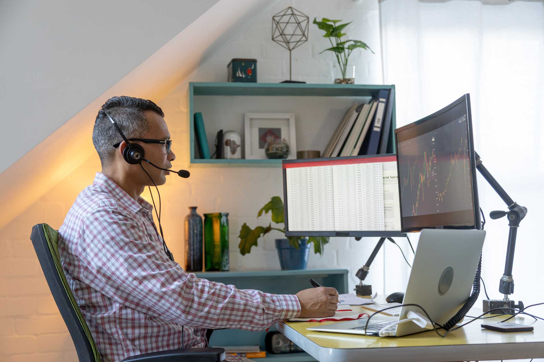Actuary-working-with-two-screens-and-a-headset-best-jobs-with-business-degree