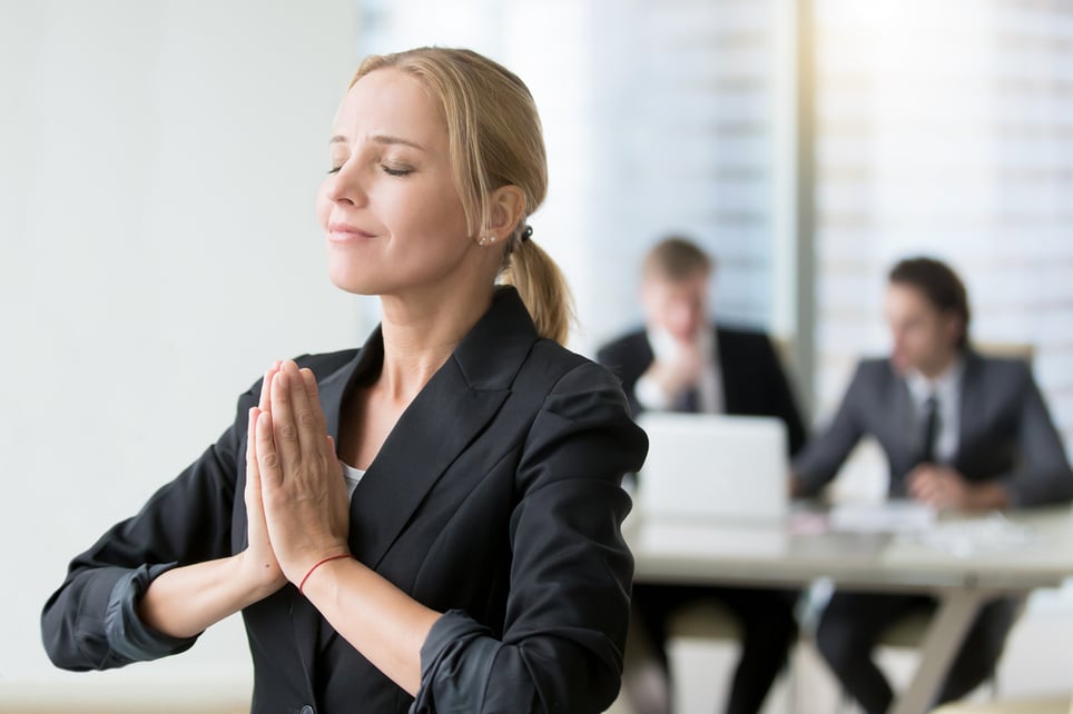 Blonde-woman-meditating-in-office-work-life-balance-in-startups