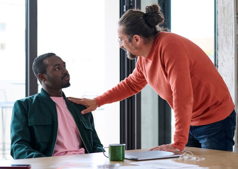 Boss-touching-shoulder-of-employee