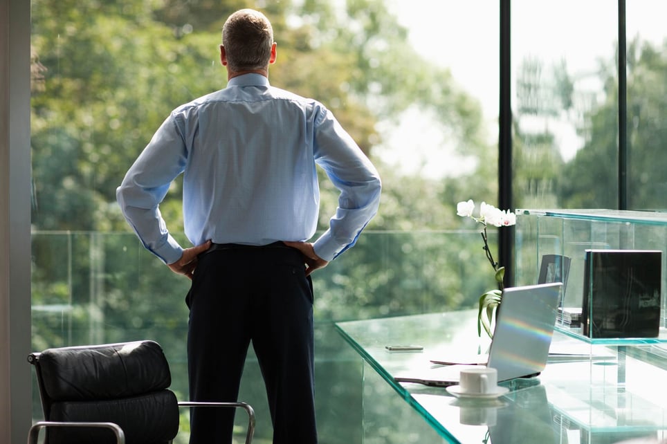 Business-man-doing-superman-pose-alone-at-office-power-poses