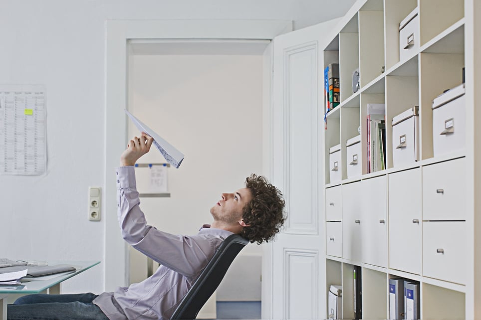 Businessman-holding-paper-airplane-difficulty-concentrating
