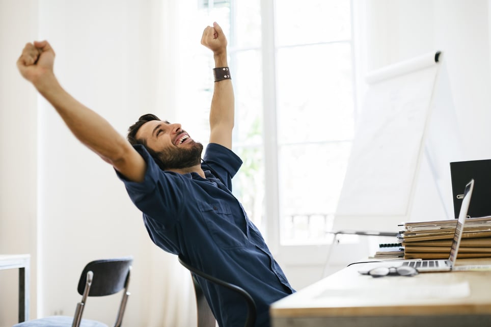 Businessman-stretching-at-desk-monthly-goals-examples