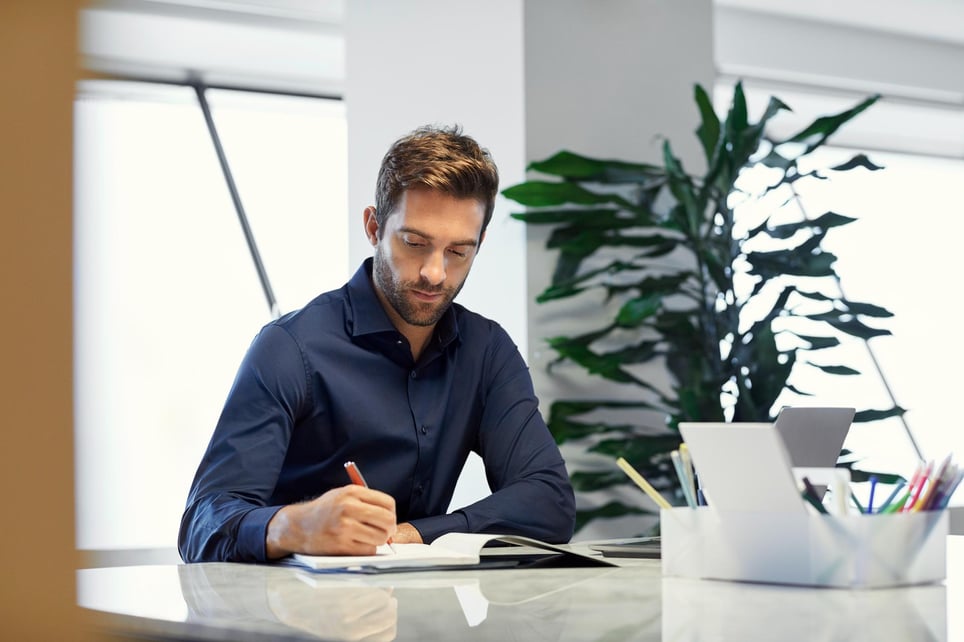 Businessman-writing-in-diary-career-statement