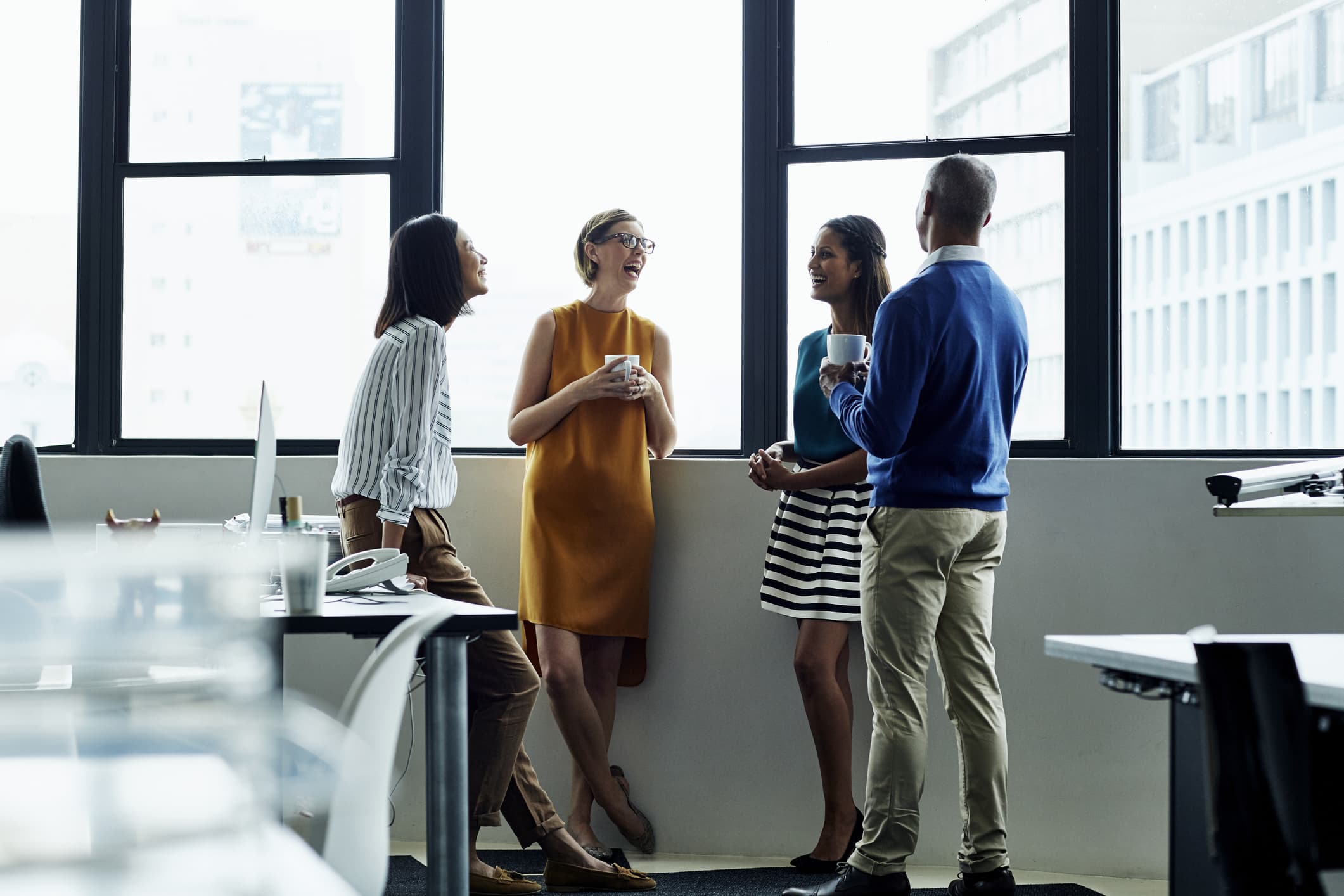 Cheerful-business-people-standing-by-office-smart-goals-examples