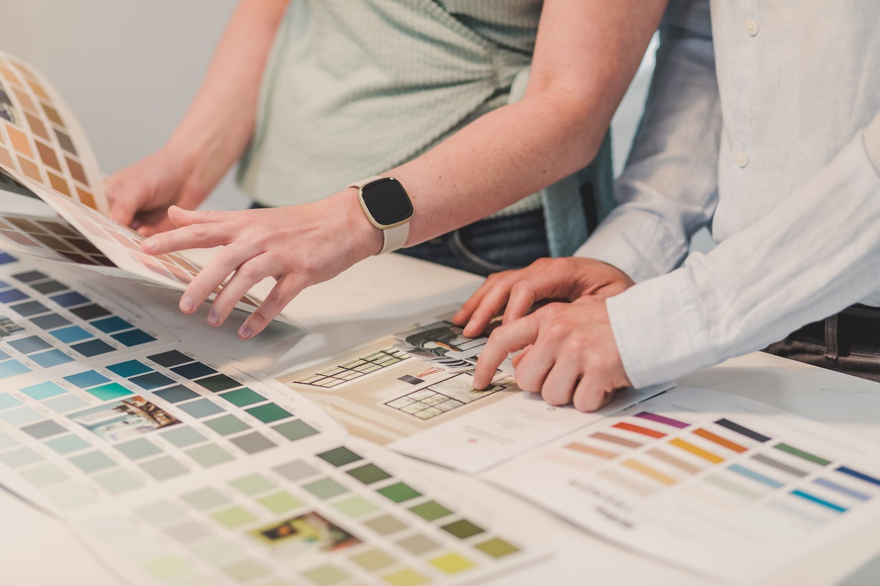 Close-up-of-hands-pointing-at-color-palettes-personal-branding
