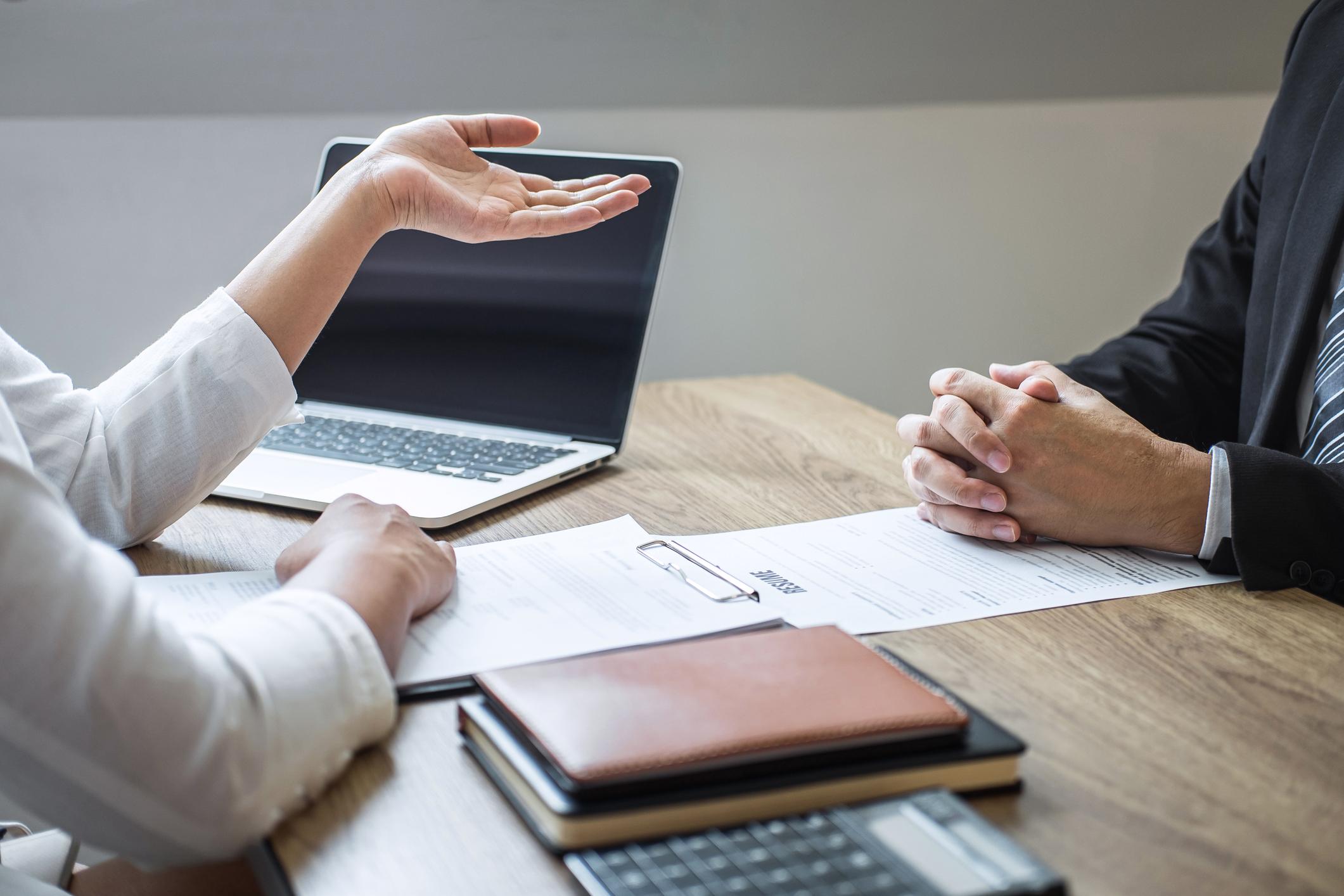 Close-up-of-two-people-having-a-conversation-at-an-interview-what-motivates-you