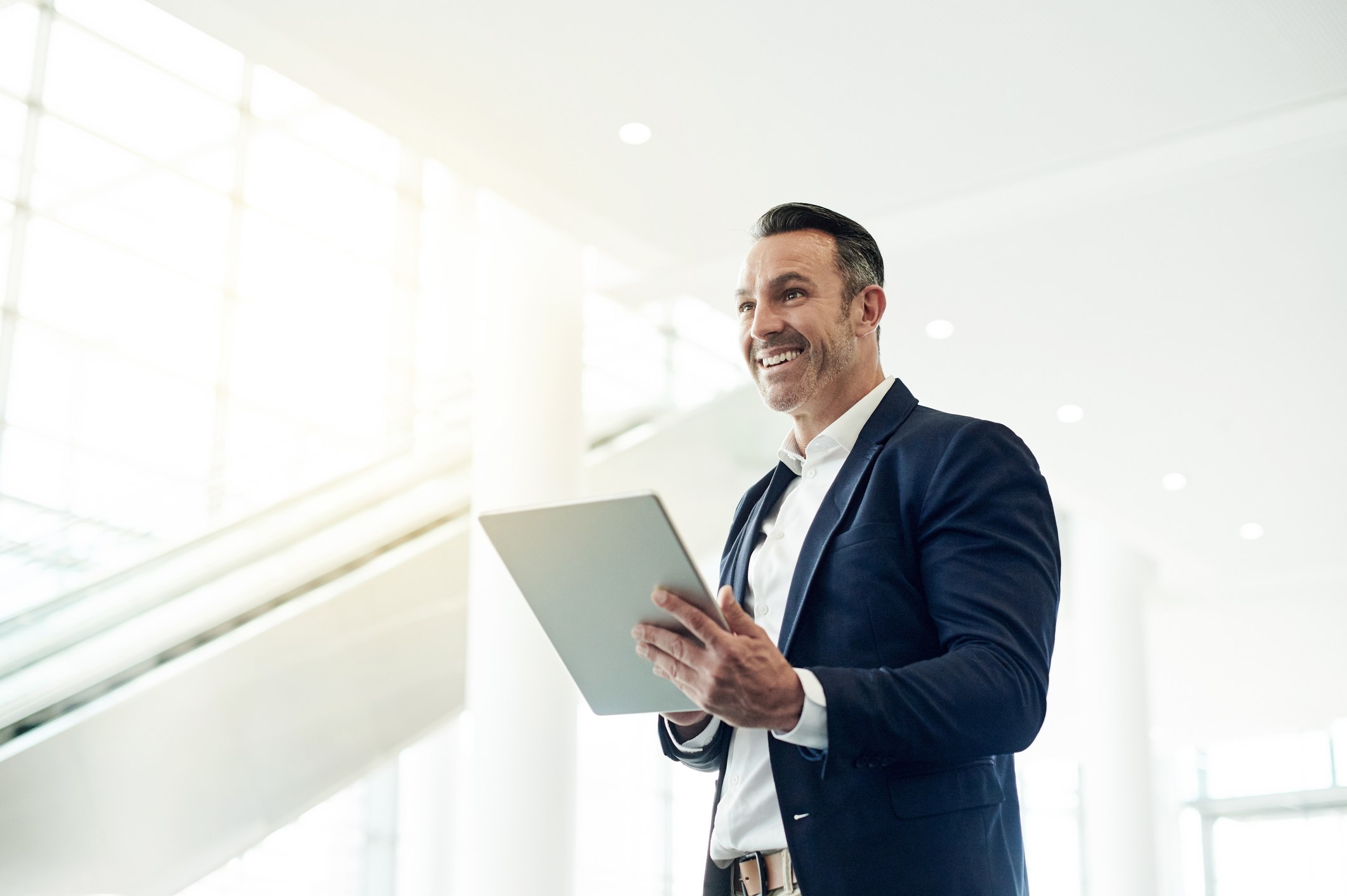 Confident-man-at-work-holding-his-tablet-how-to-improve-self-determination