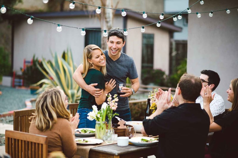 Couple-Making-An-Announcement-At-A-Backyard-Dinner-Party-how-to-challenge-yourself