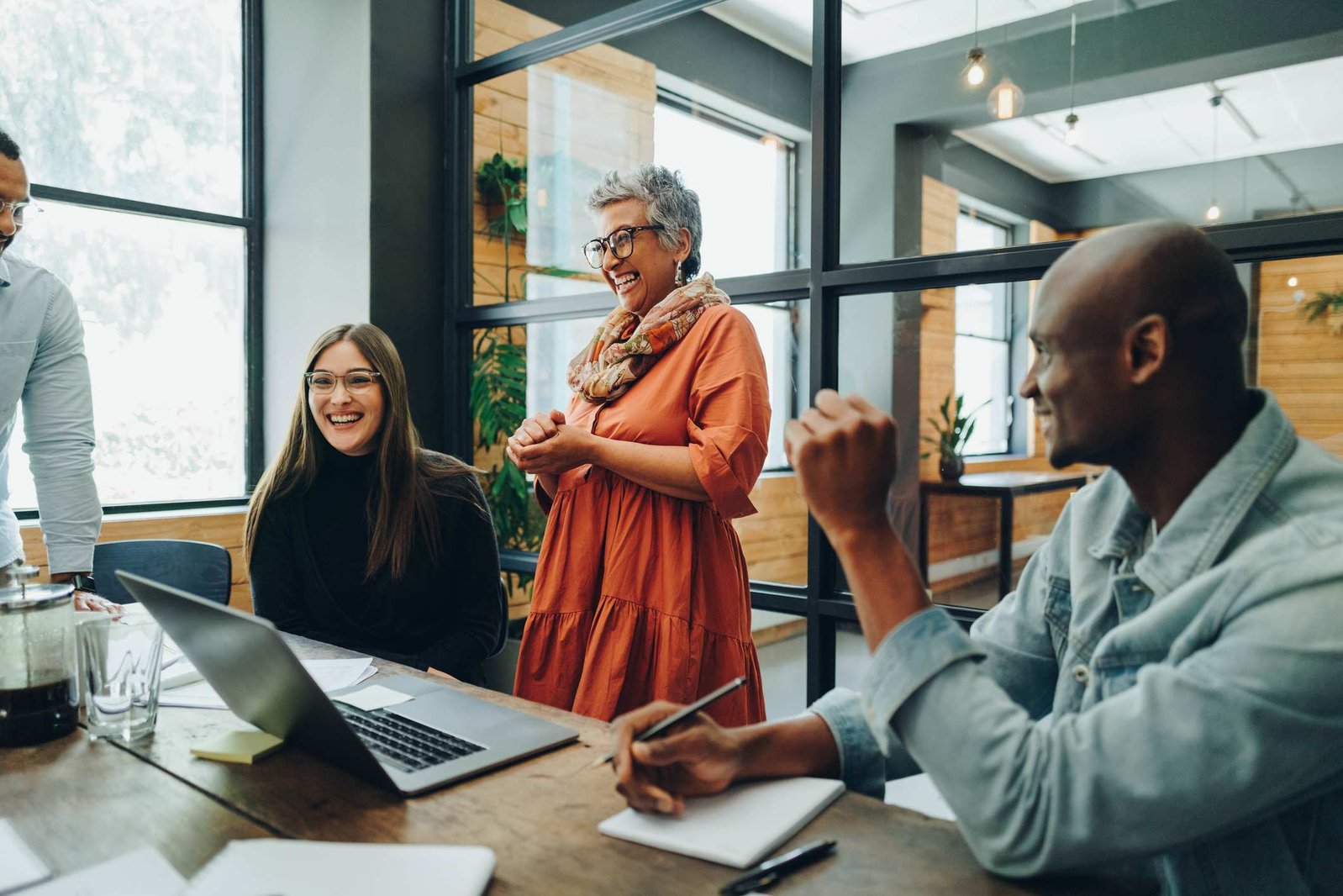 Coworkers-smiling-and-laughing-at-work-meeting-employee-strengths