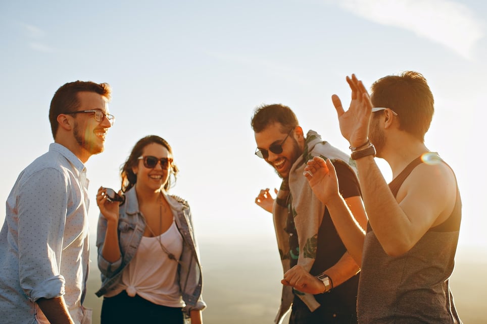 Four-friends-laughing-while-watching-sunset-autonomy-in-a-relationship