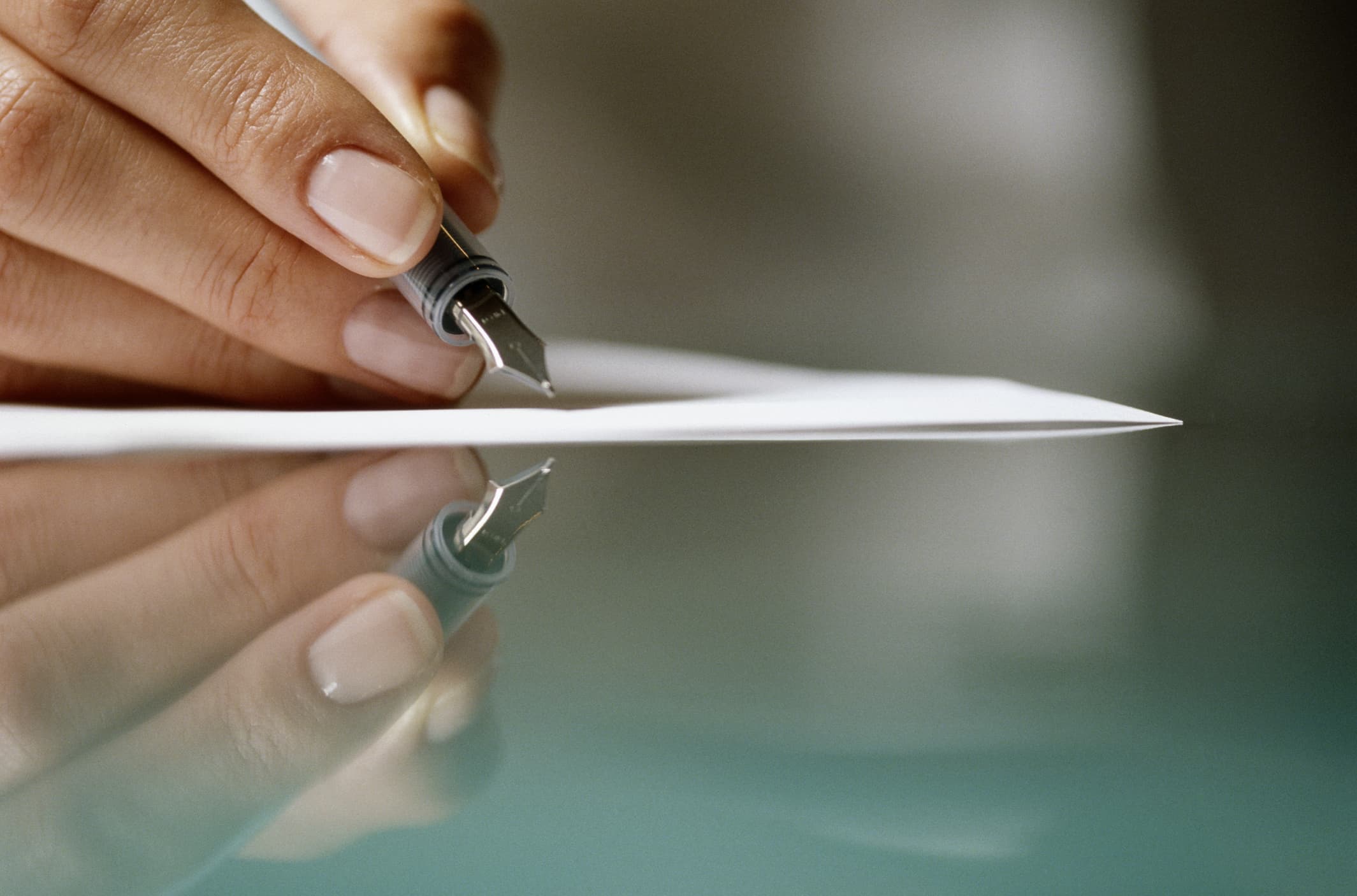 woman-writing-on-paper-reflected-in-glass-purpose-of-career-counseling