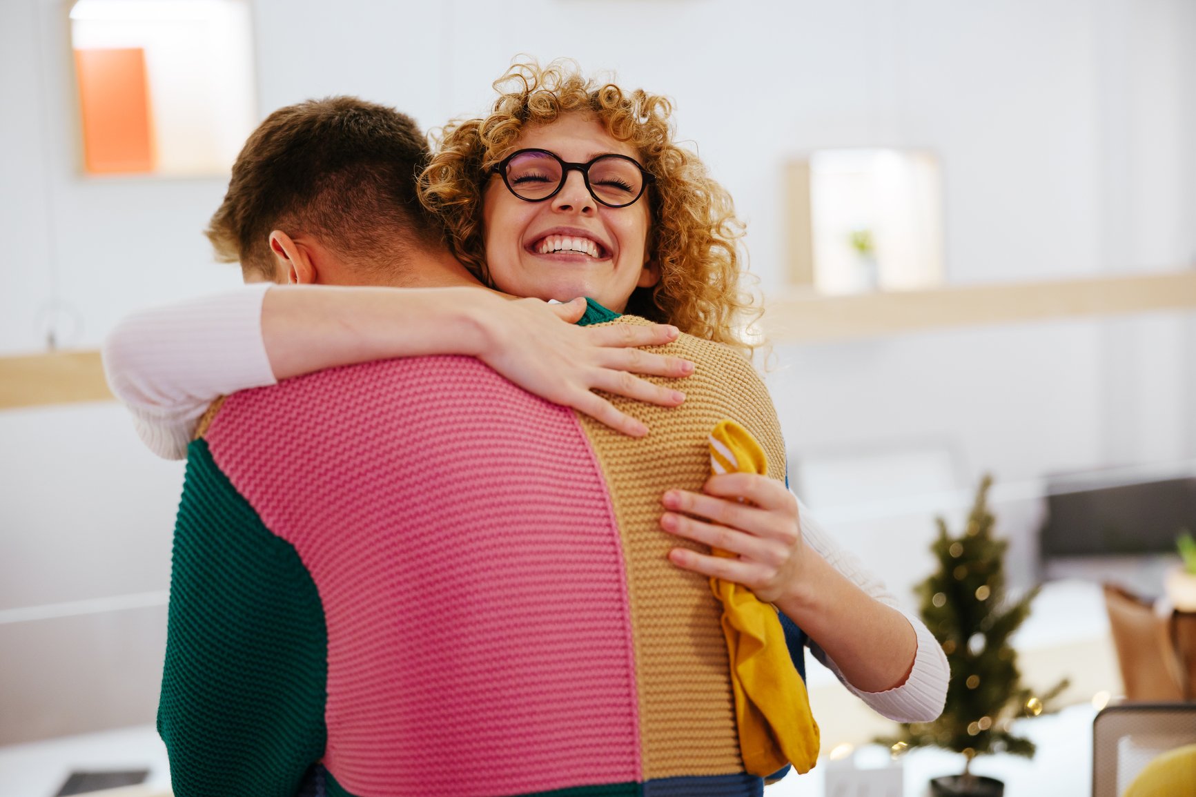 Happy-Woman-Hugging-Male-Colleague-thank-you-to-a-team