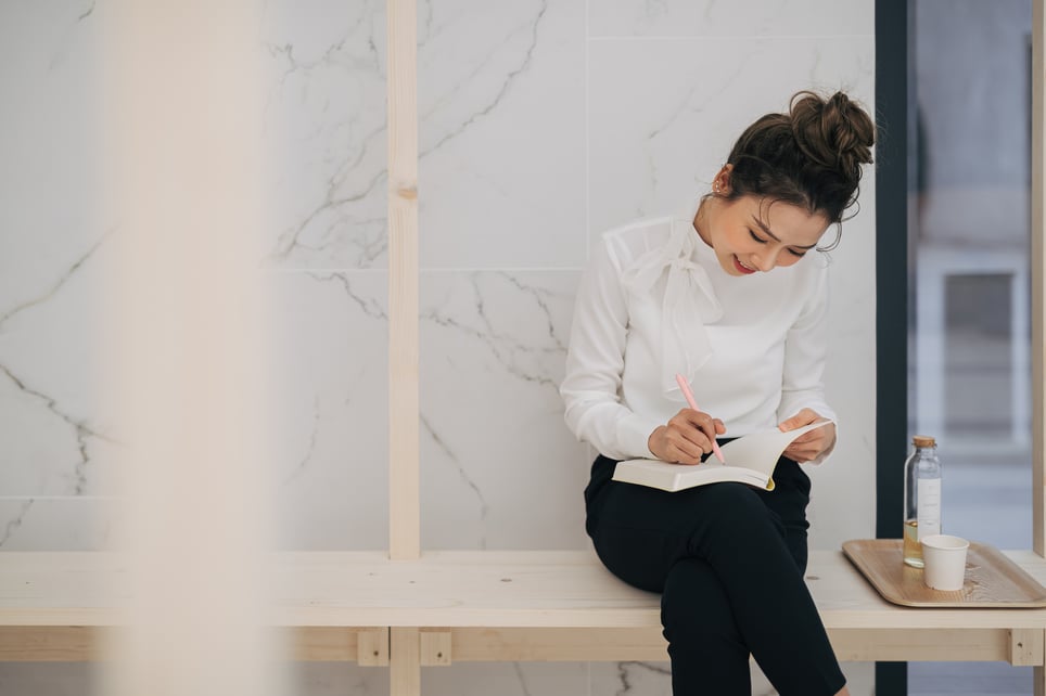 Happy-Woman-With-Notebook-how-to-begin-self-discovery
