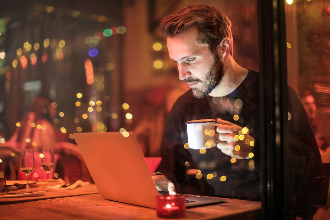 Man-Holding-Mug-in-Front-of-Laptop-life-goals
