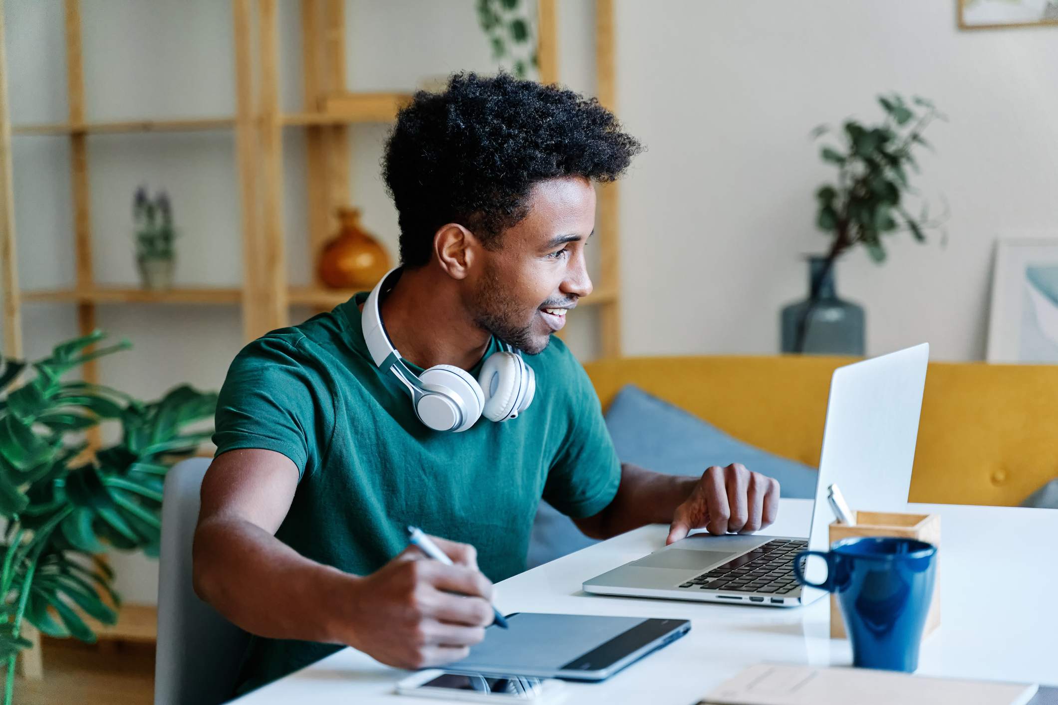 Man-alone-working-on-computer-with-headphones-jobs-for-introverts