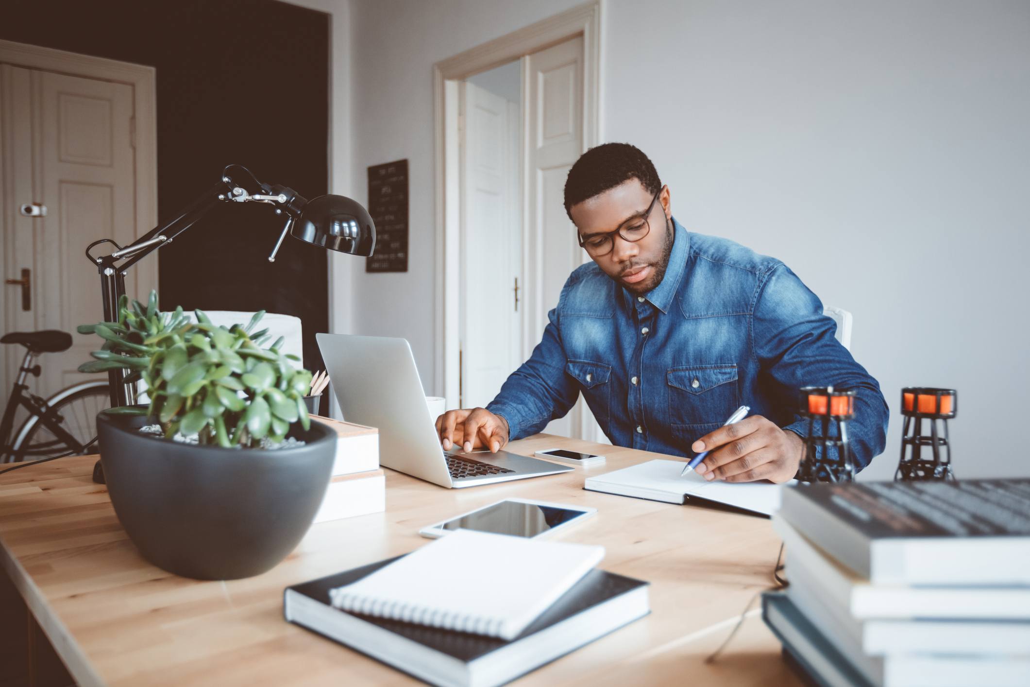 Man-at-his-office-writing-down-on-a-notebook-protect-your-energy