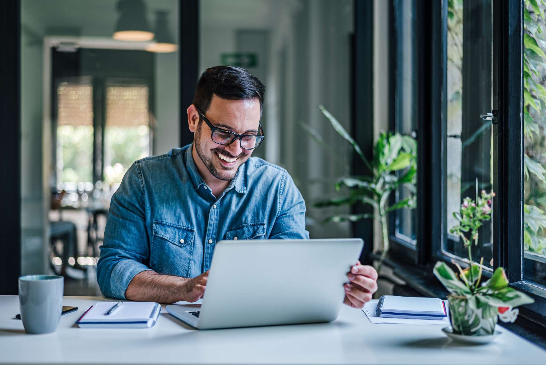 Man-at-home-happy-and-smiling-with-laptop-and-coffee-how-emotions-affect-learning