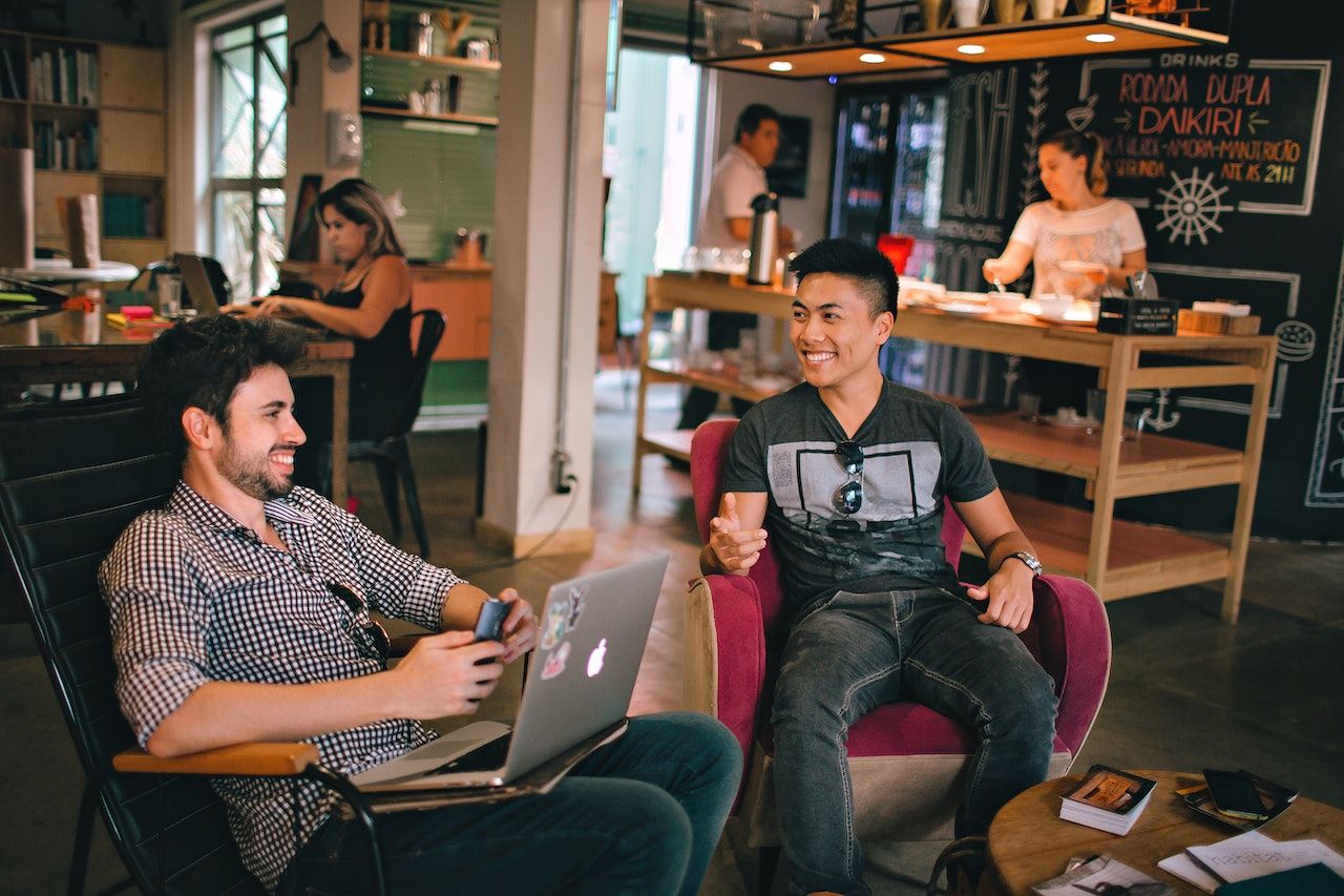 Man-meeting-friend-at-coffee-shop-smiling-things-to-manifest-ideas