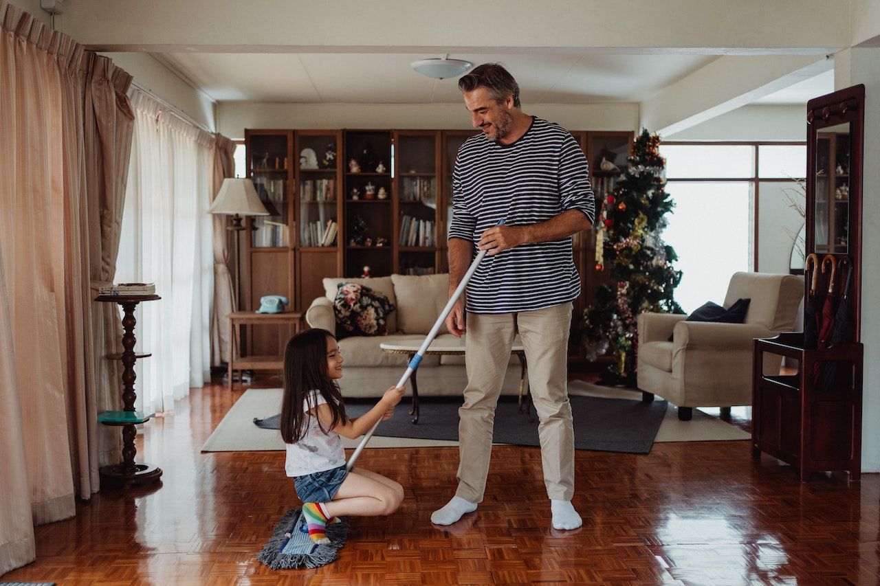 Man-with-daughter-mopping-their-house-floor-quality-time-with-family