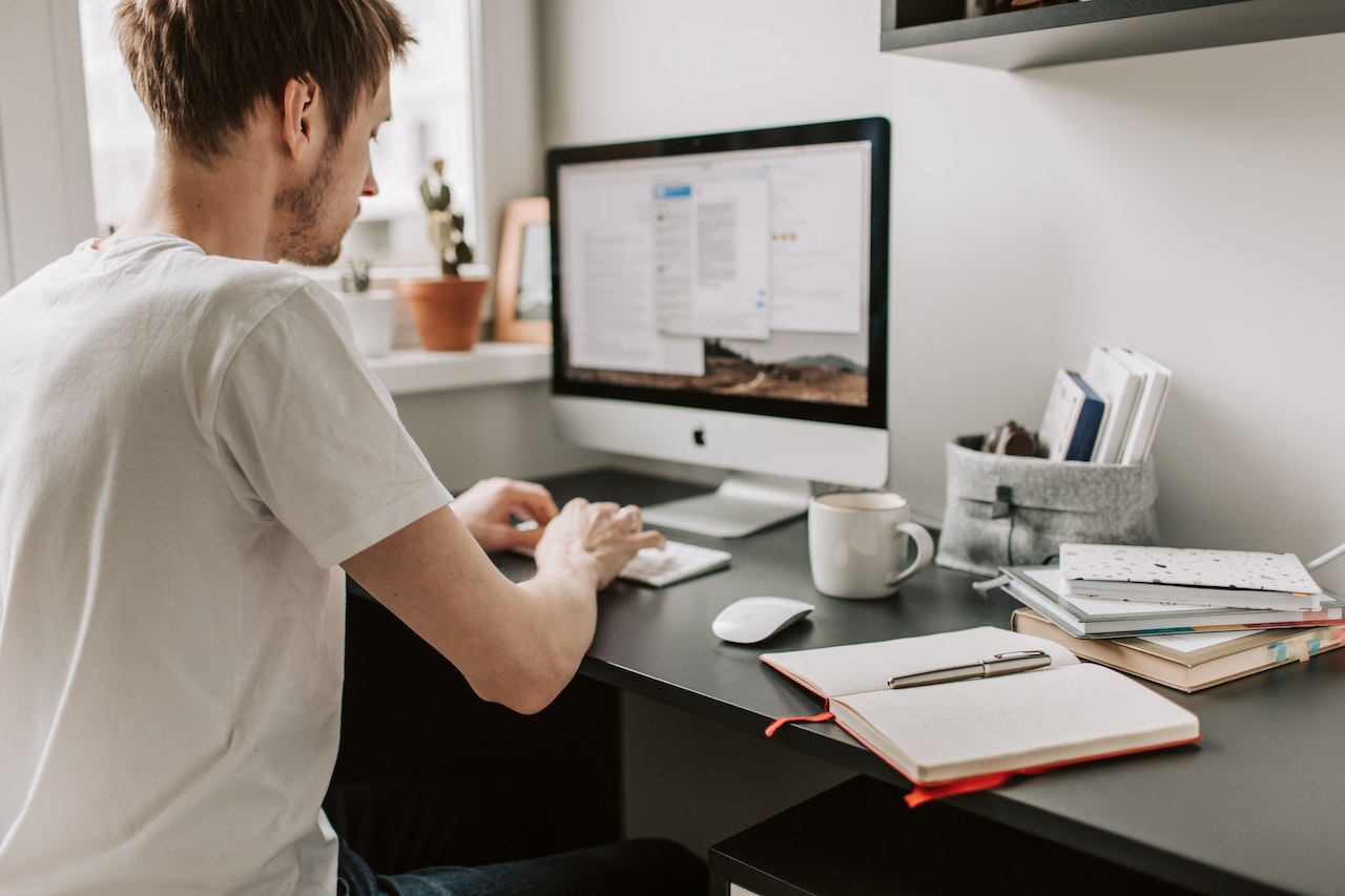 Man-working-on-his-computer-at-home-personal-brand-statement
