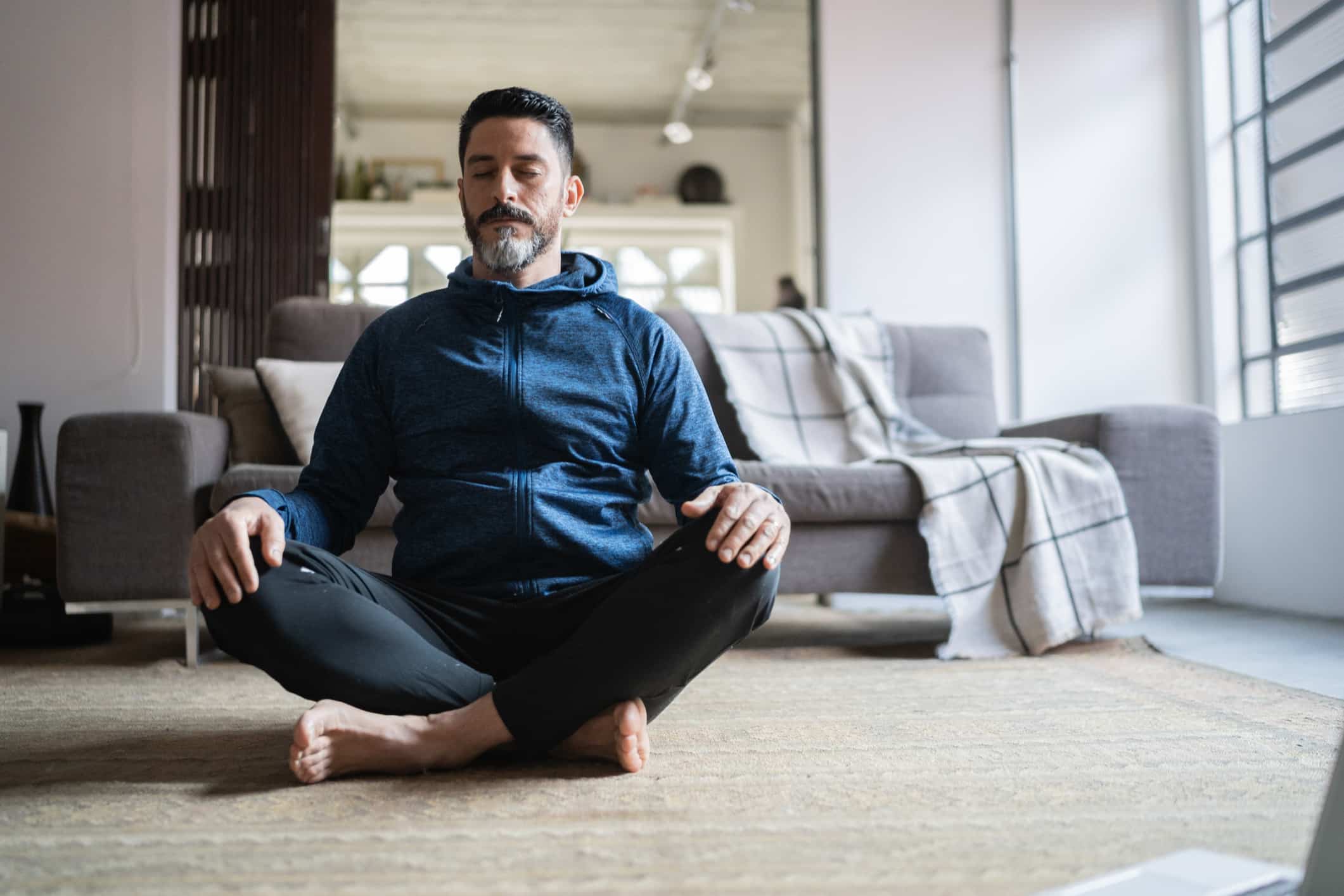 Mature-man-meditating-at-home-biofeedback-for-stress