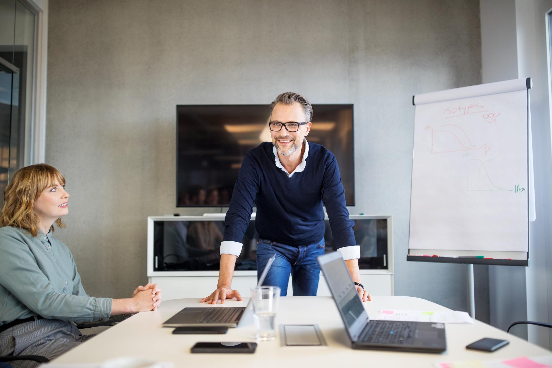Mid-adult-businessman-leading-a-board-room-meeting-appreciate-a-team