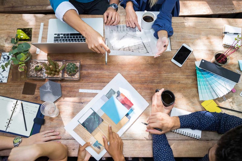 Overhead-View-Of-A-Desk-Of-People-Working-On-A-Project