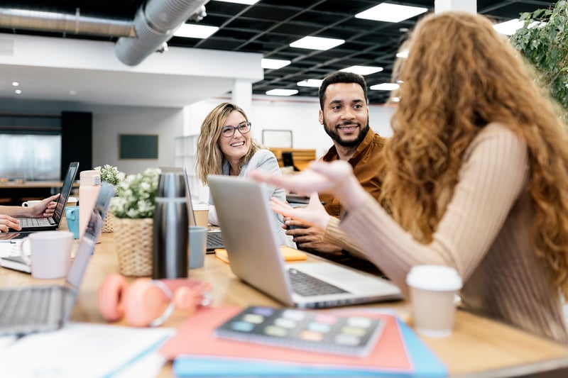 Side-View-Of-Coworkers-Chatting-In-Office