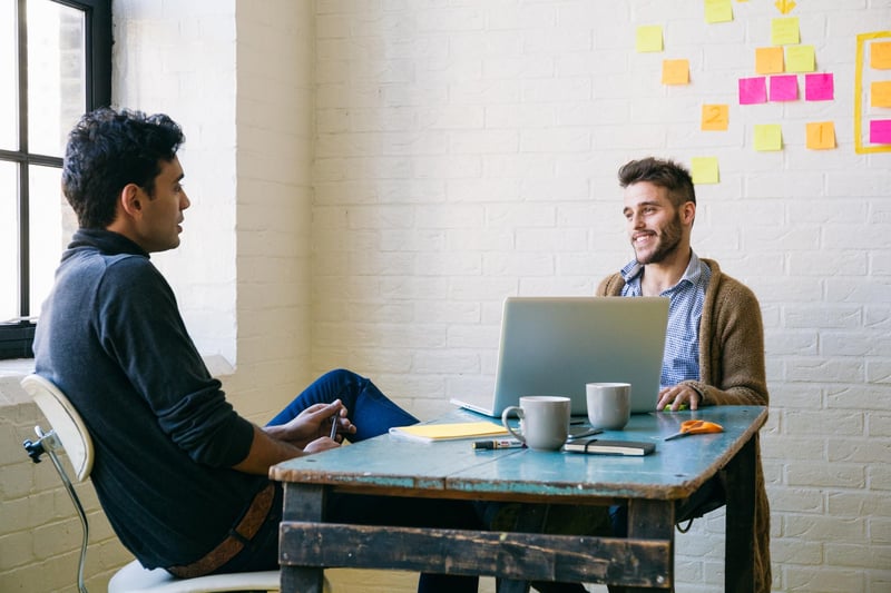 Smiling-Business-Men-At-Desk