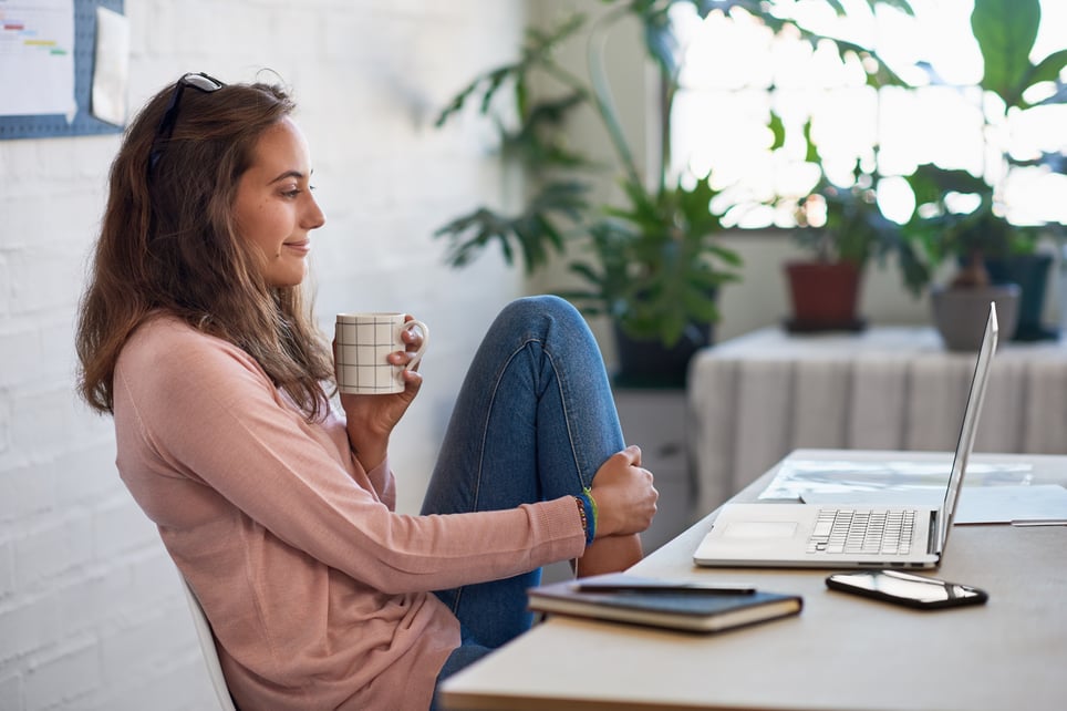 Smiling-Woman-Reading-Emails-In-The-Morning-thank-you-to-a-team