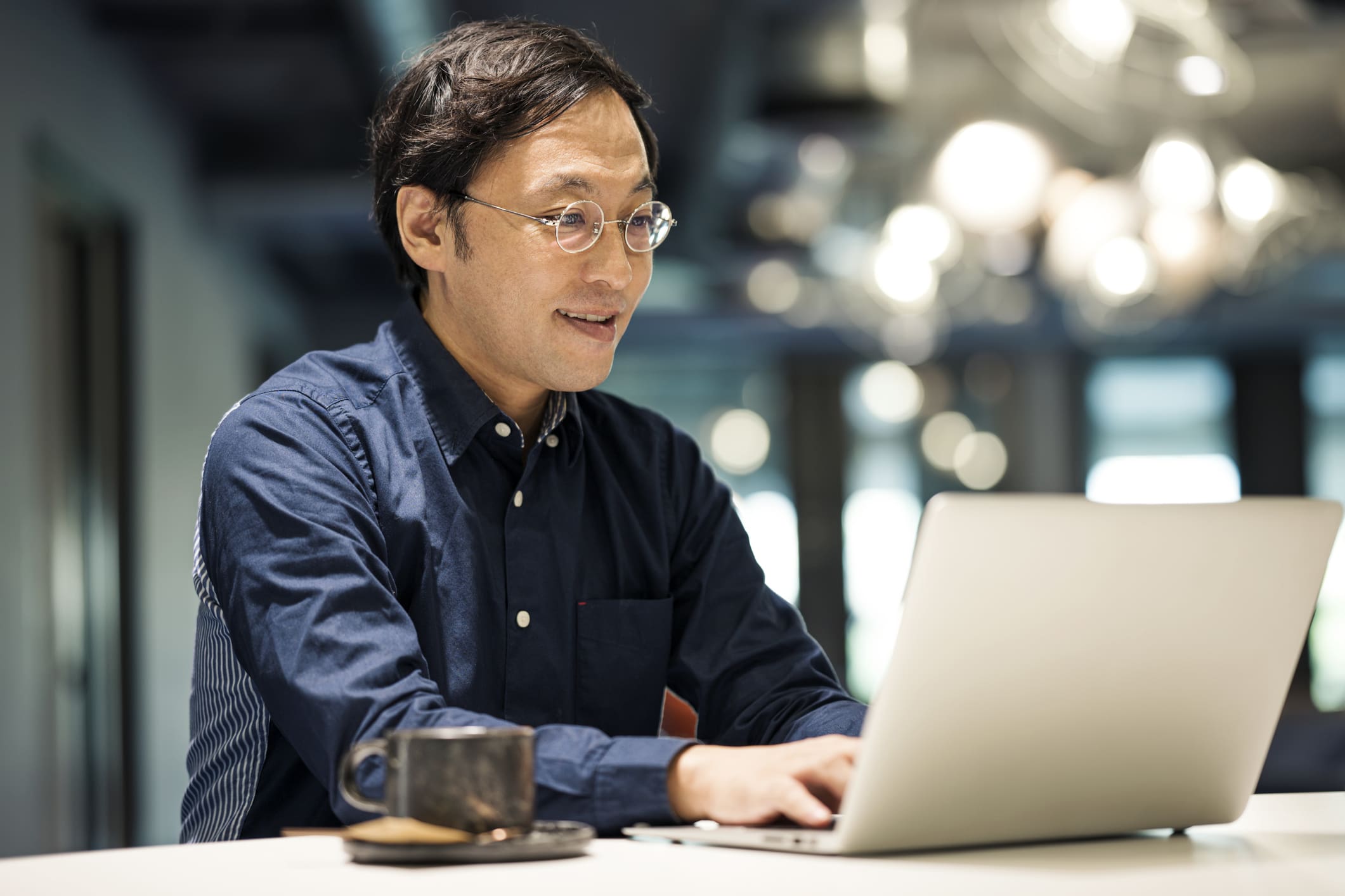 Smiling-man-looking-at-work-laptop-stretch-goals