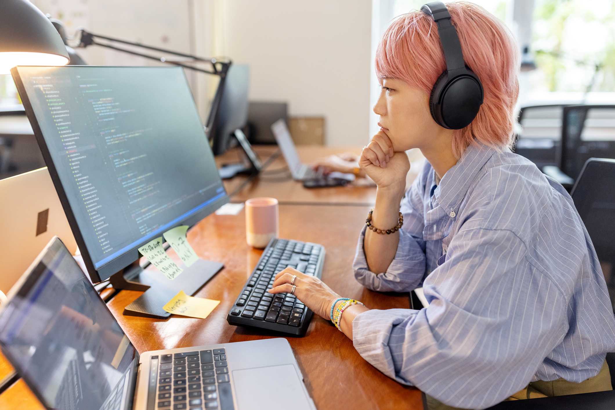 Software-engineer-woman-working-at-office-with-headphones-on-jobs-for-introverts