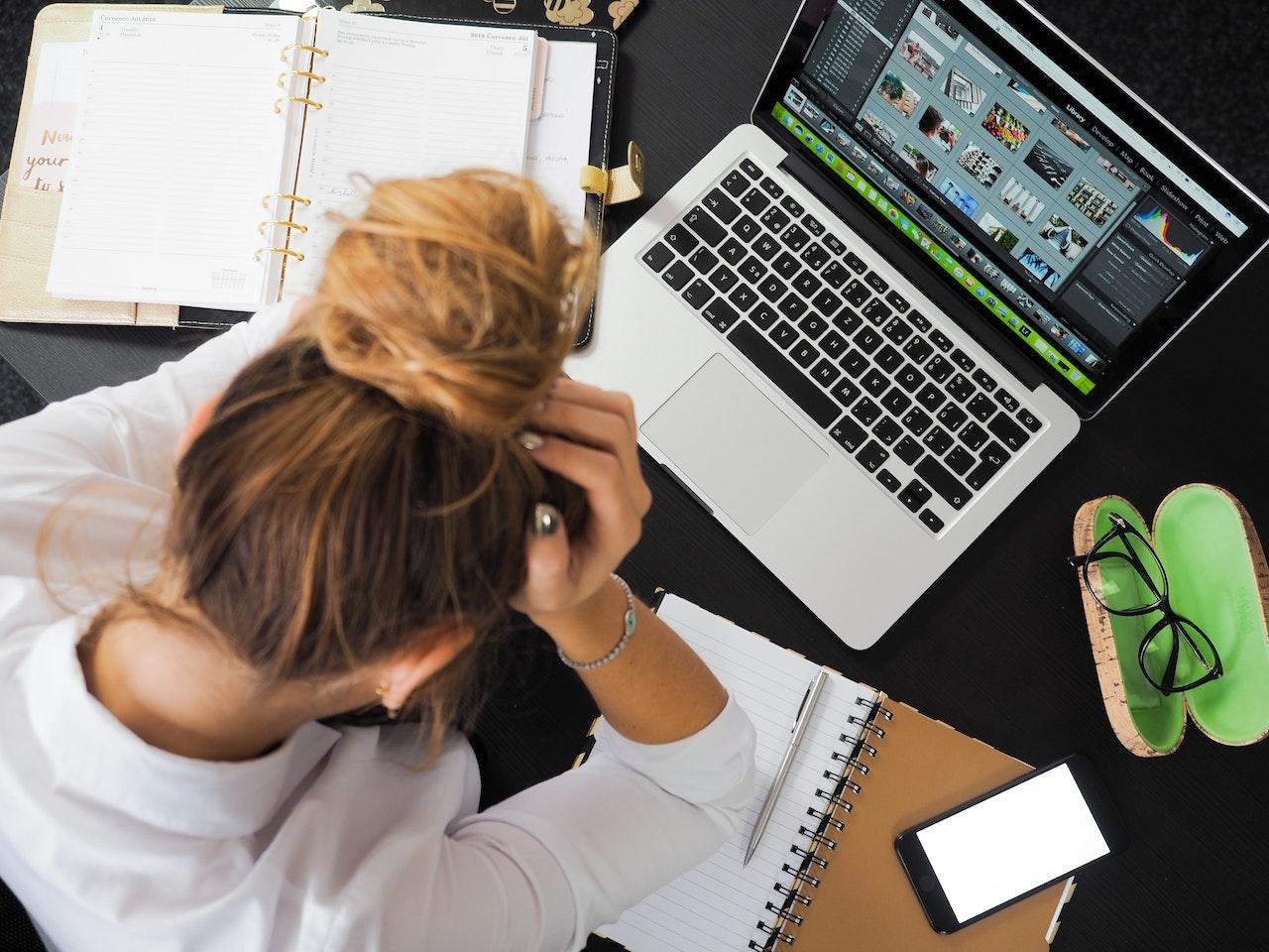 Stressed-woman-covering-her-face-while-using-laptop-decision-making-skills