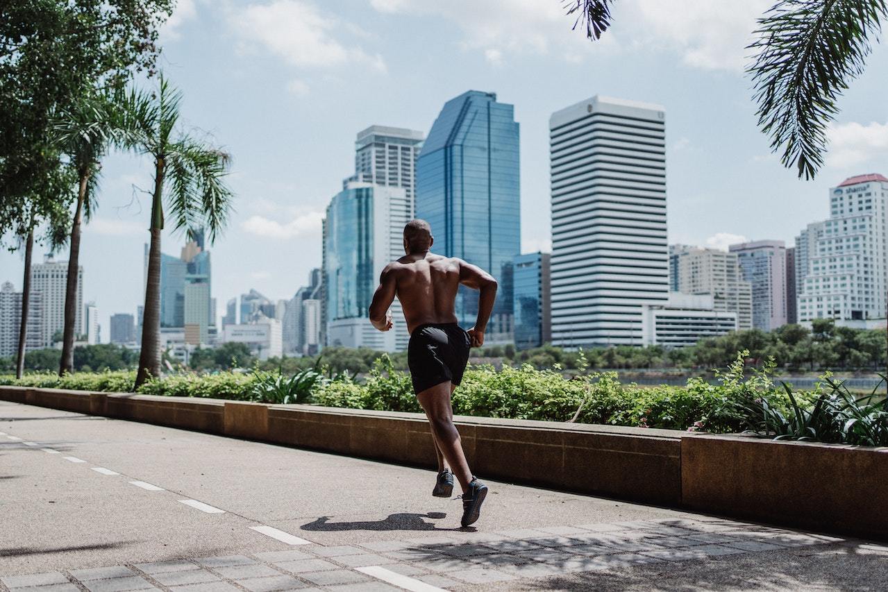 Strong-and-muscular-man-running-shirtless-outdoors-exercise-benefits