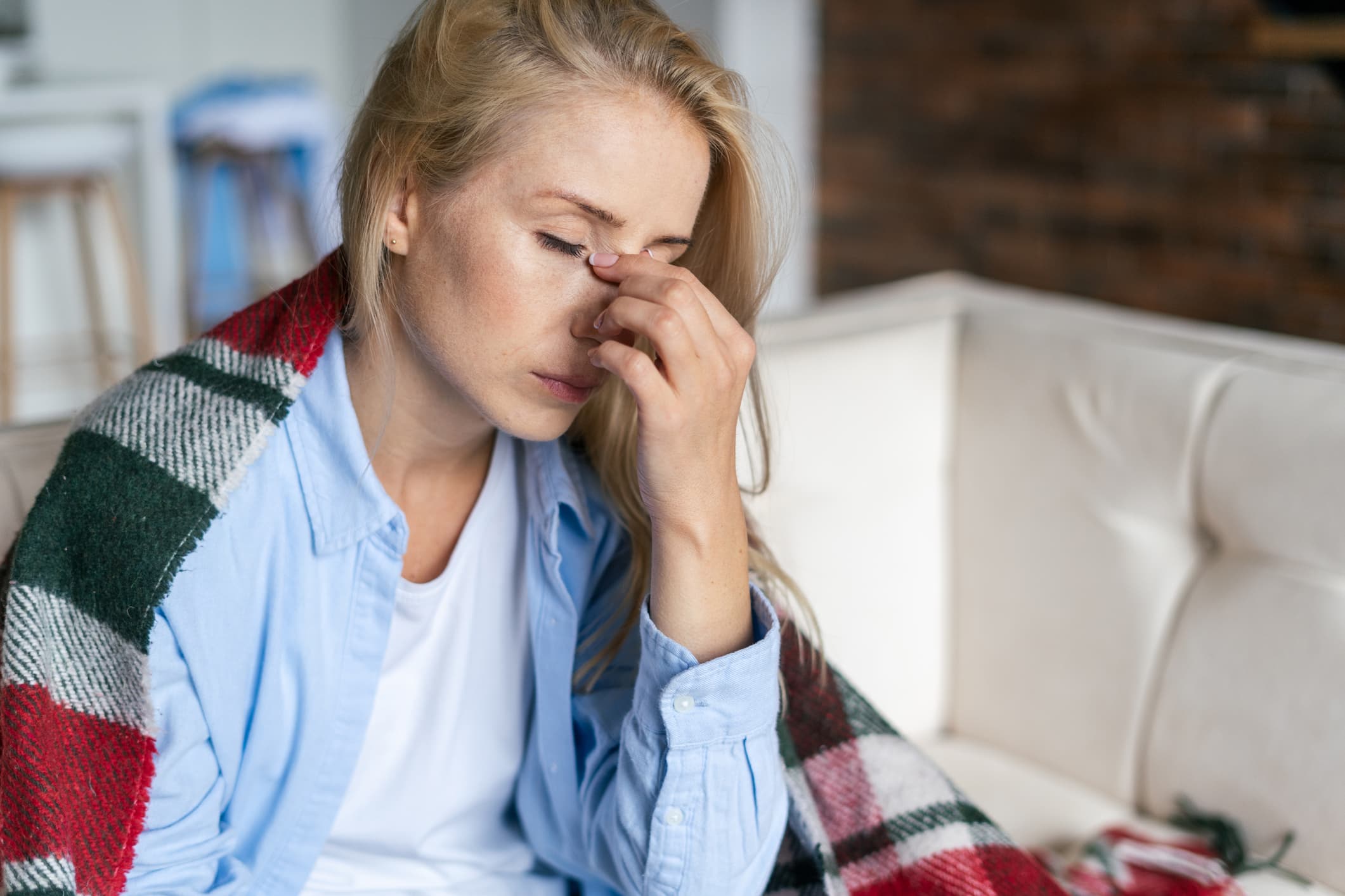 Tired-woman-with-closed-eyes-touching-her-nose-biofeedback-for-stress