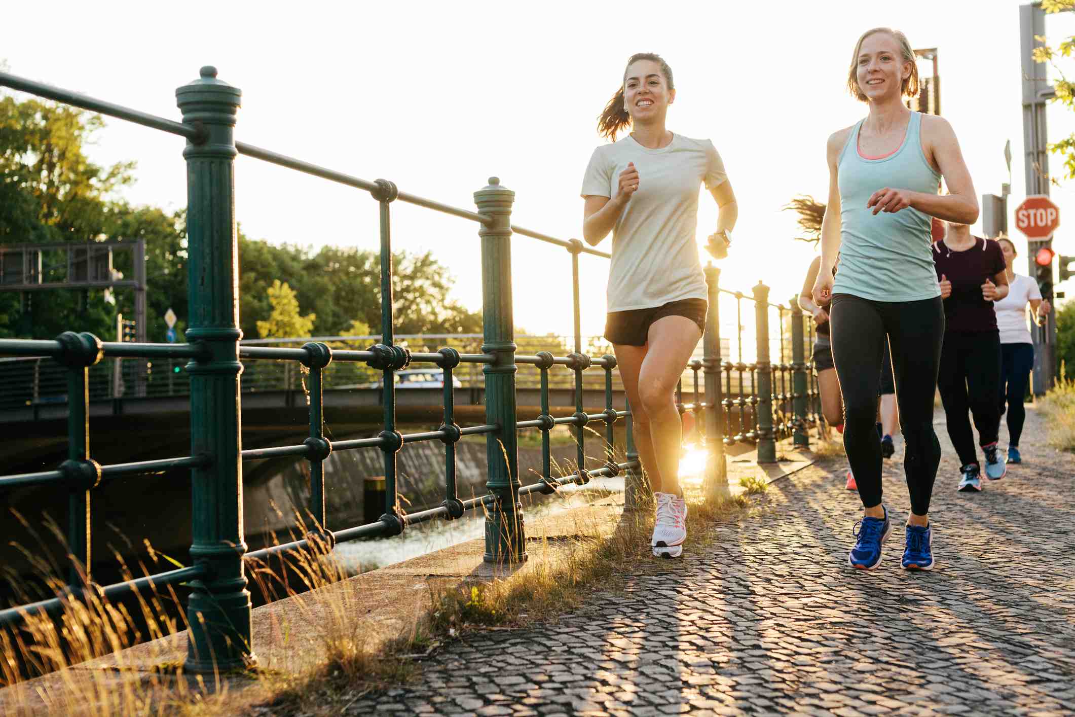 Two-happy-women-running-outdoors-at-sunset-how-to-release-endorphins
