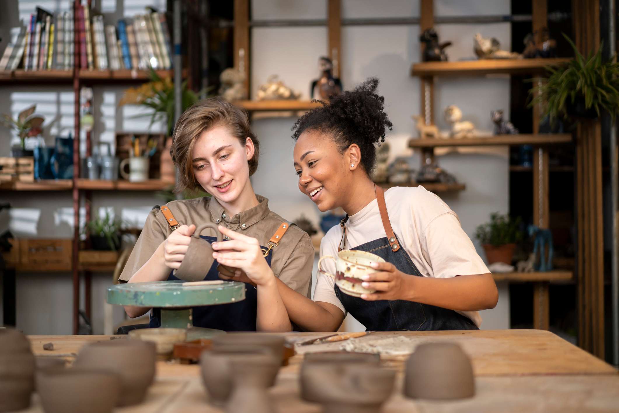 Two-woman-at-pottery-class-laughing-together-i-feel-like-i-dont-belonggydF4y2Ba