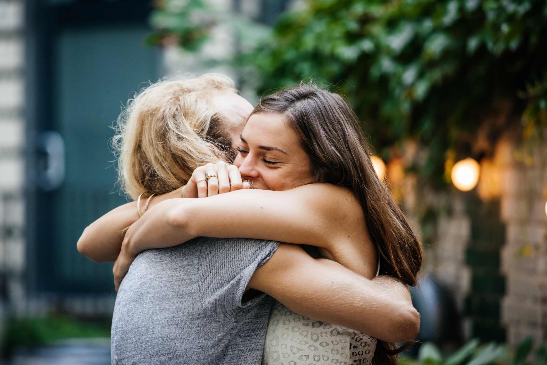 Two-woman-happily-hugging-outdoors-protect-your-energy