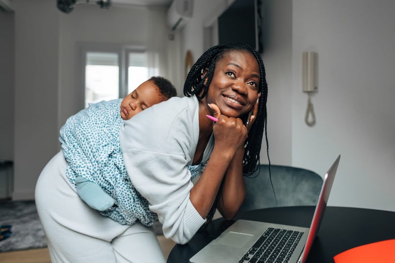 Woman-Holding-Baby-And-Using-Laptop-success-tips