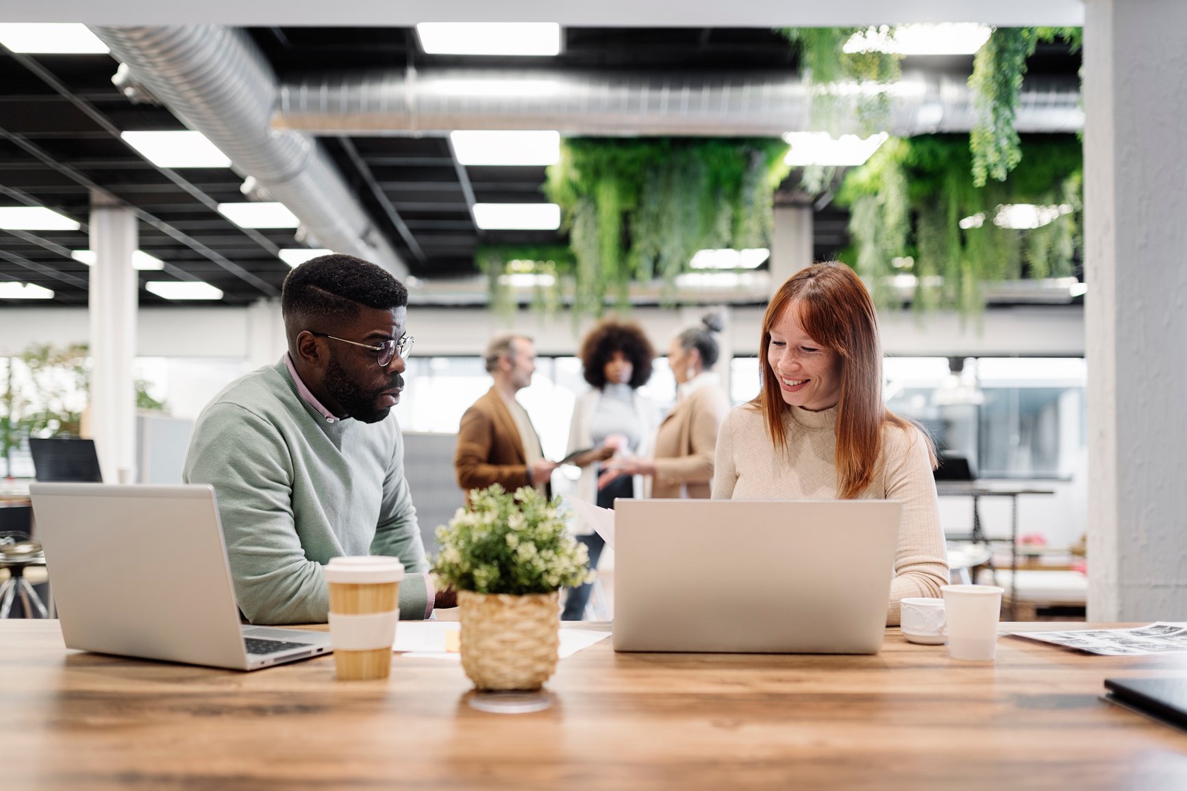 Woman-In-Her-40s-With-Male-Colleague-Talking-In-Office-career-change-at-40