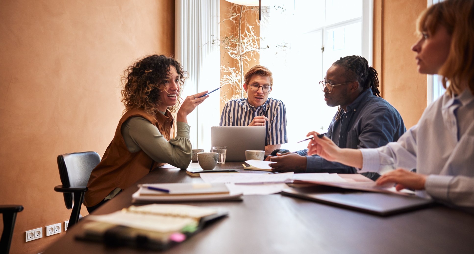 Woman-Talking-With-Coworkers-building-good-work-relationships