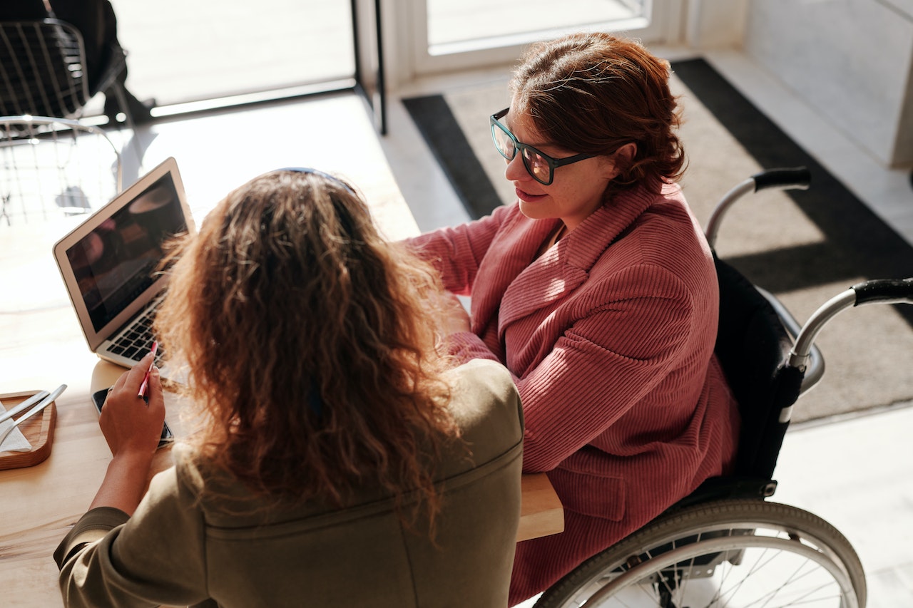 Woman-in-a-wheelchair-talking-to-her-collegue-at-office-jobs-that-wont-be-automated