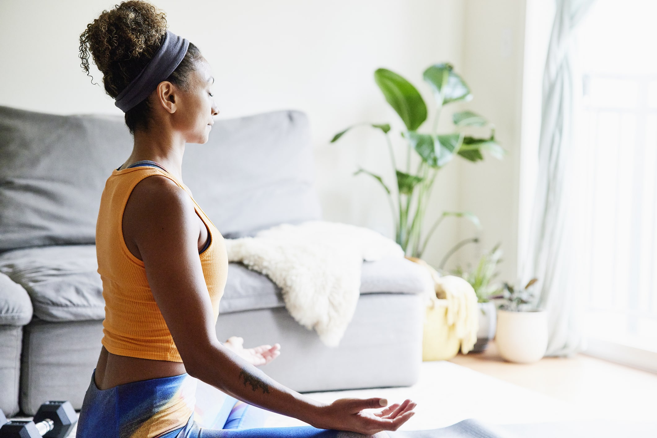 Woman-in-lotus-position-in-living-room-the-importance-of-knowing-yourself