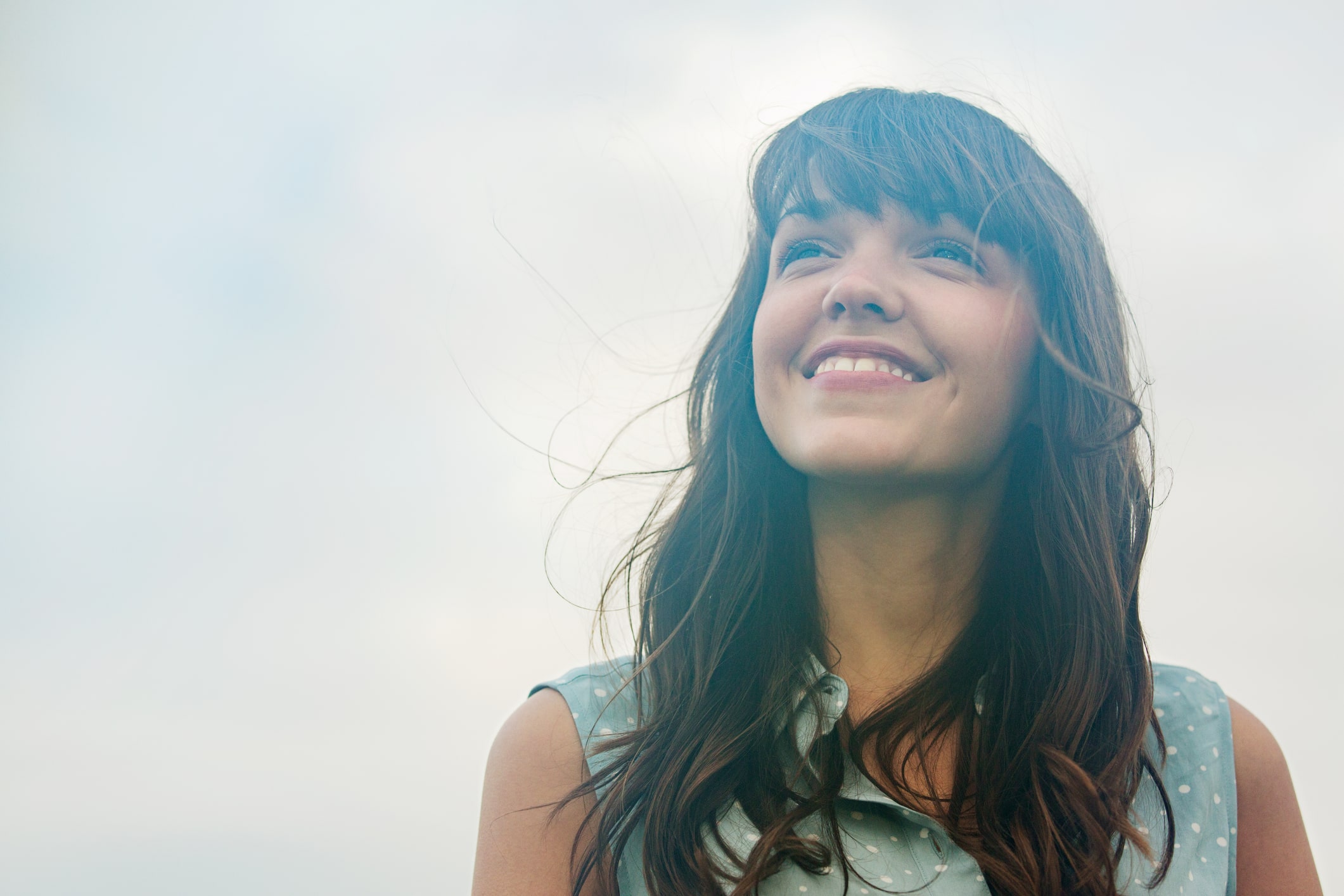 Woman-looking-up-and-smiling-self-motivation-examples