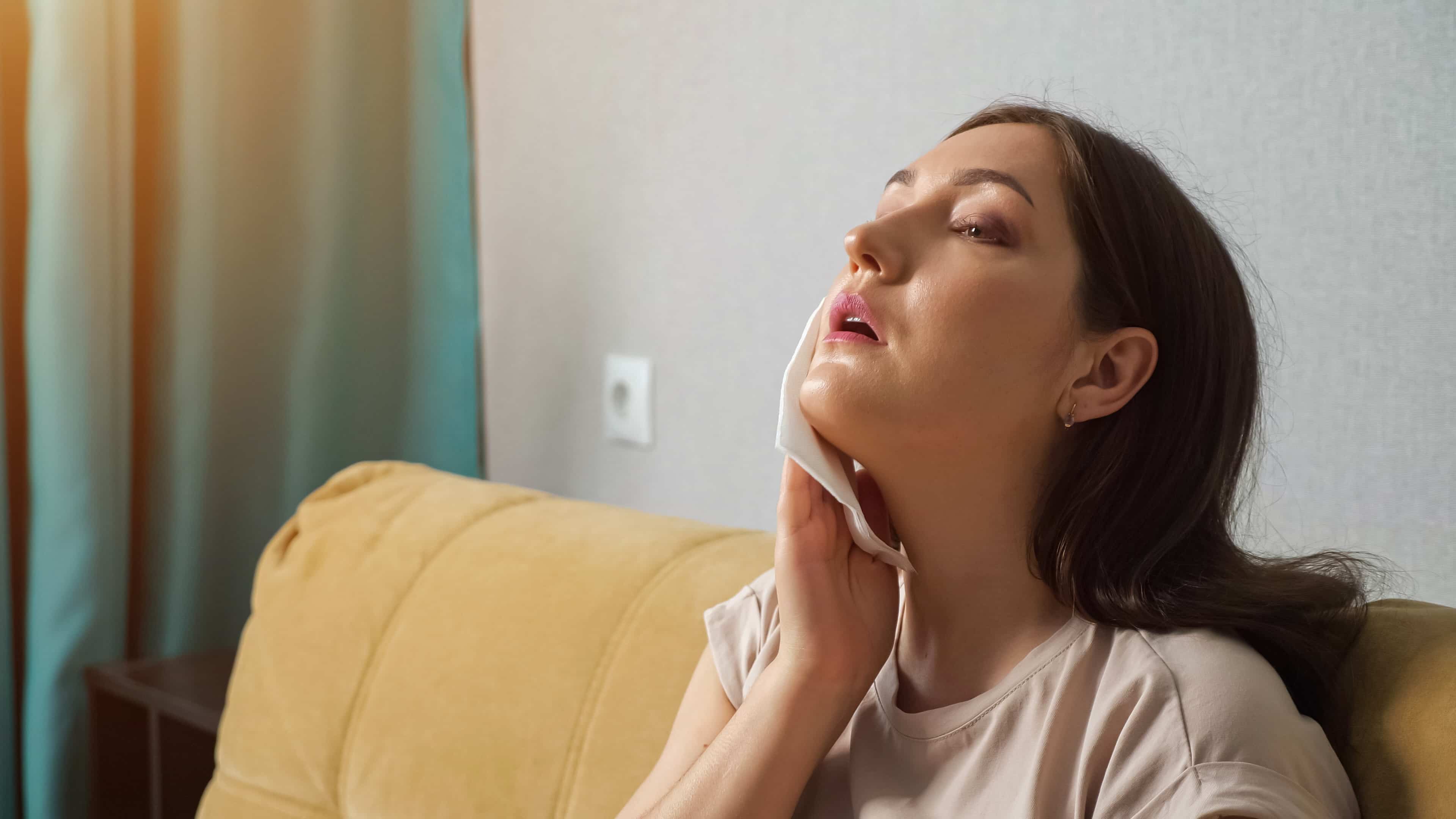 Woman-suffering-from-the-heat-wiping-biofeedback-for-stress