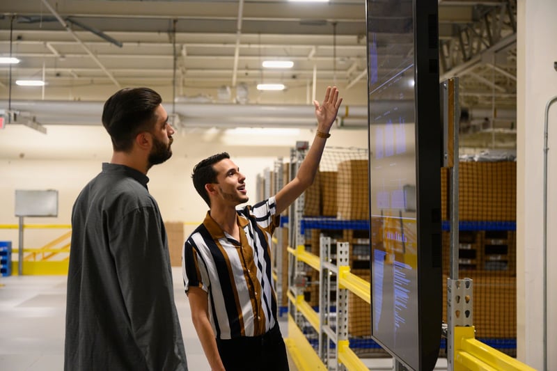Workers-Discuss-Productivity-At-Factory-Warehouse