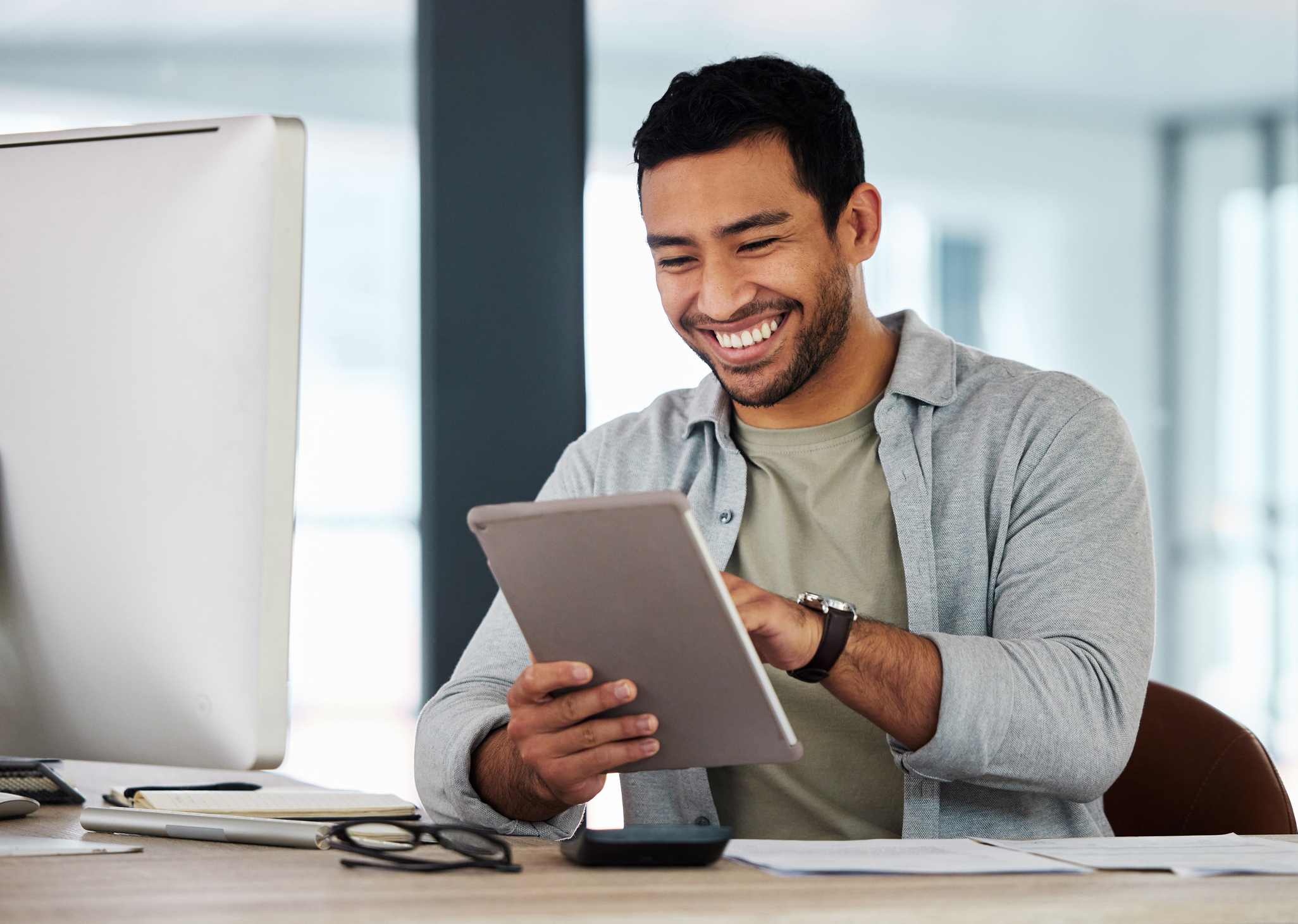 Young-businessman-using-his-digital-tablet-advantages-of-intrinsic-motivation