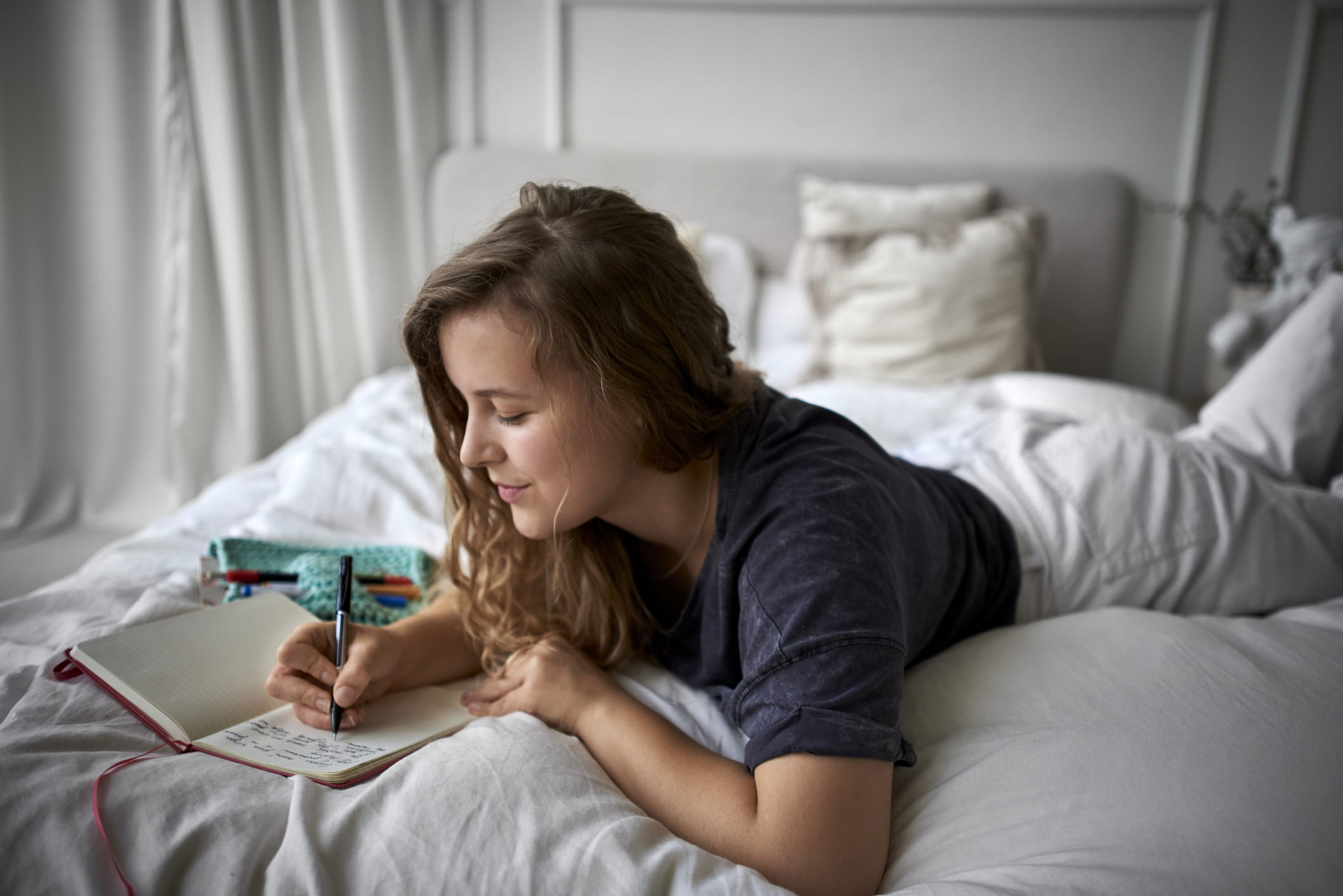 Young-woman-journaling-before-bed-revenge-bedtime-procrastination