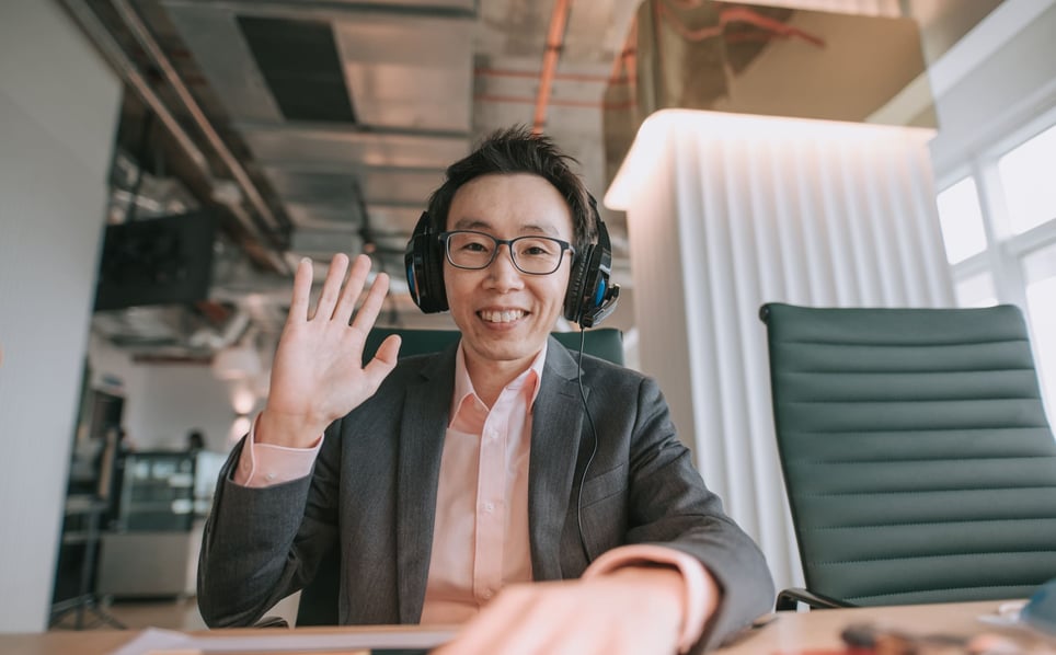 businessman-waving-at-the-computer-video-interview