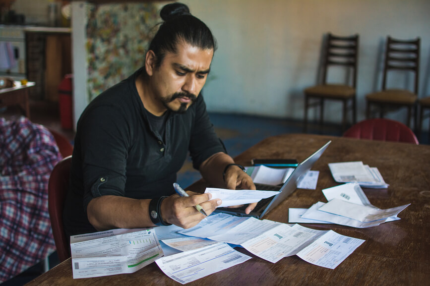 concerned-man-working-through-bills-types-of-stress